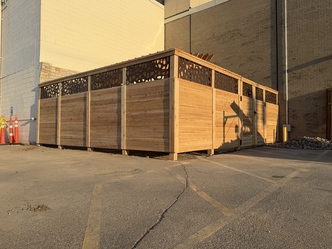 custom commercial wood fence enclosure with decorative panels in twin cities mn