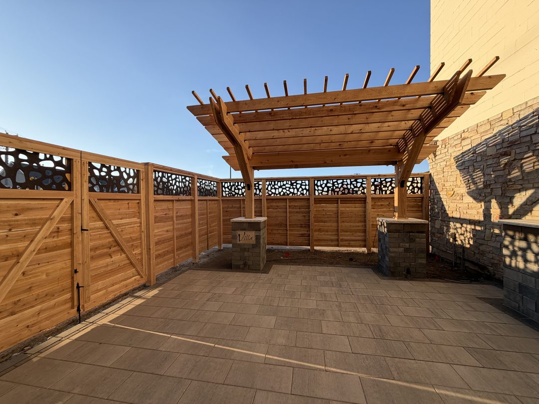 custom wood pergola with decorative fence on paver patio in twin cities mn